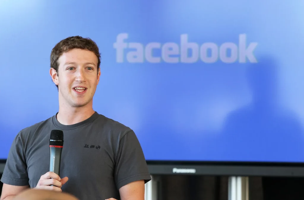 Mark Zuckerberg with Facebook logo behind