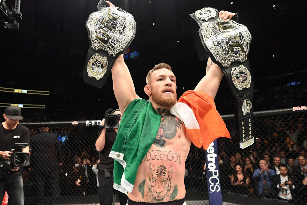 Conor McGregor with 2 UFC belts