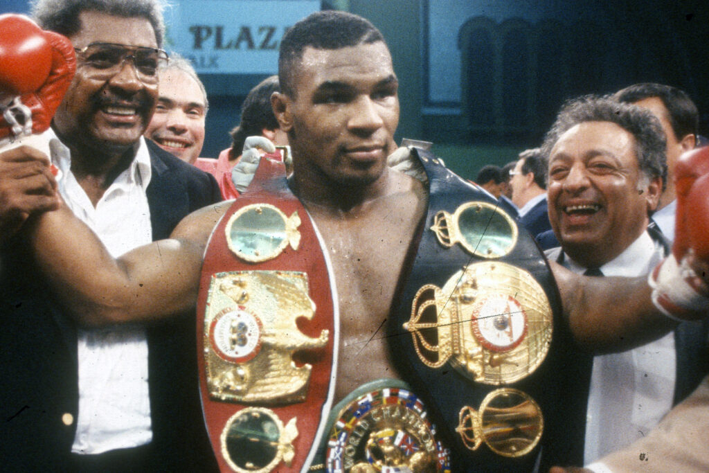 Mike Tyson with 3 championship belts